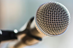 Close-up macro of microphone silhouetted against sun